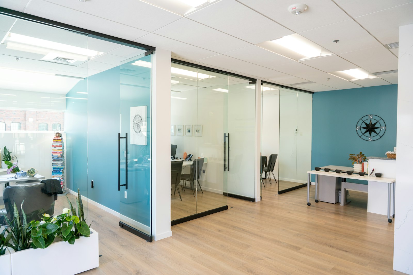 Illustrative office interior with glass partitions and wood flooring